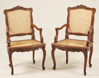 Appraisal: PAIR OF LOUIS XV STYLE CARVED WALNUT FAUTEUILS HAVING CANE