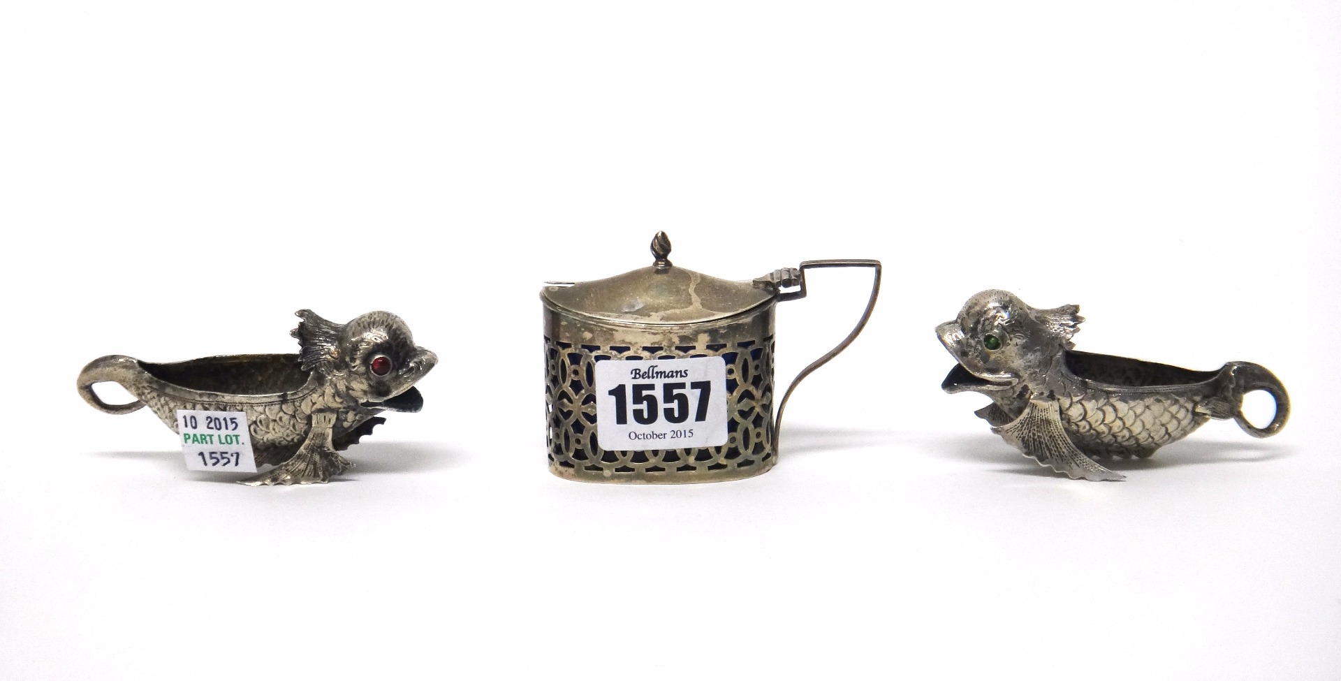 Appraisal: A silver mustard pot with pierced decoration and blue glass