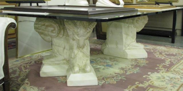 Appraisal: A neo-classical style glass top dining table with adjustable ram-motif