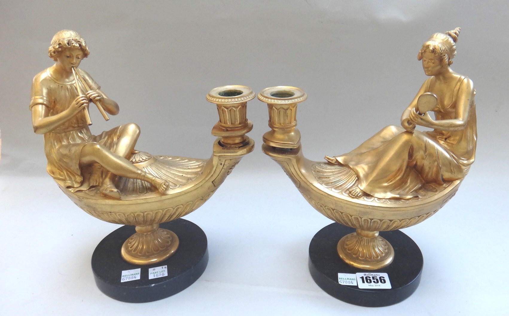 Appraisal: A pair of ormolu figural oil lamp candlesticks early th