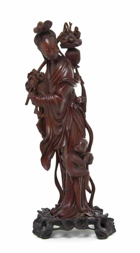 Appraisal: A Chinese Boxwood Carving of a Woman and a Monkey