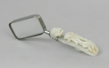 Appraisal: A Carved Jade Belt Hook Fitted with a Magnifying Glass