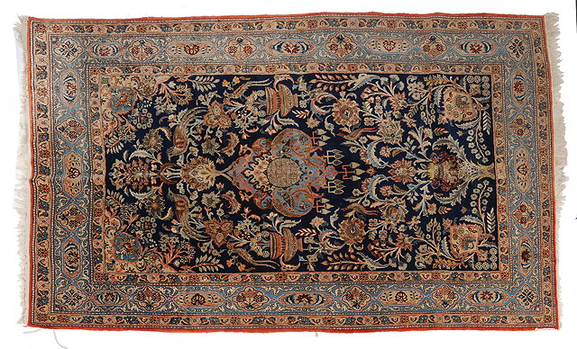 Appraisal: A KASHAN DARK BLUE GROUND PICTORIAL RUG a classical urn