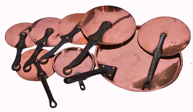 Appraisal: SEVEN TH CENTURY COPPER SAUCEPAN LIDS with iron handles the