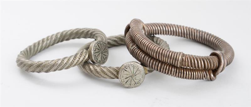 Appraisal: TWO SIMILAR SOLID METAL TWIST BRACELETS WITH DISC JOINTS AND