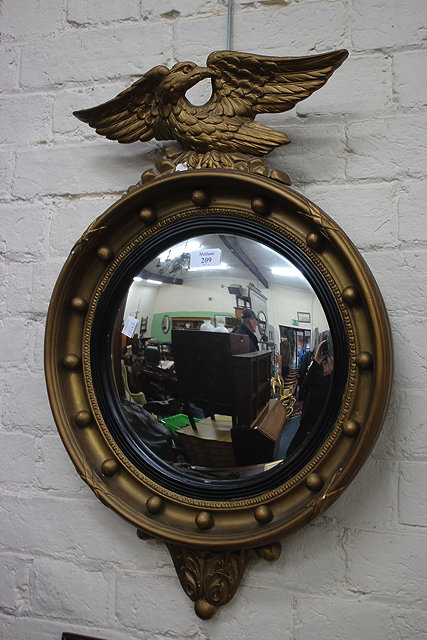 Appraisal: A REGENCY STYLE GILT FRAMED CIRCULAR WALL MIRROR with convex