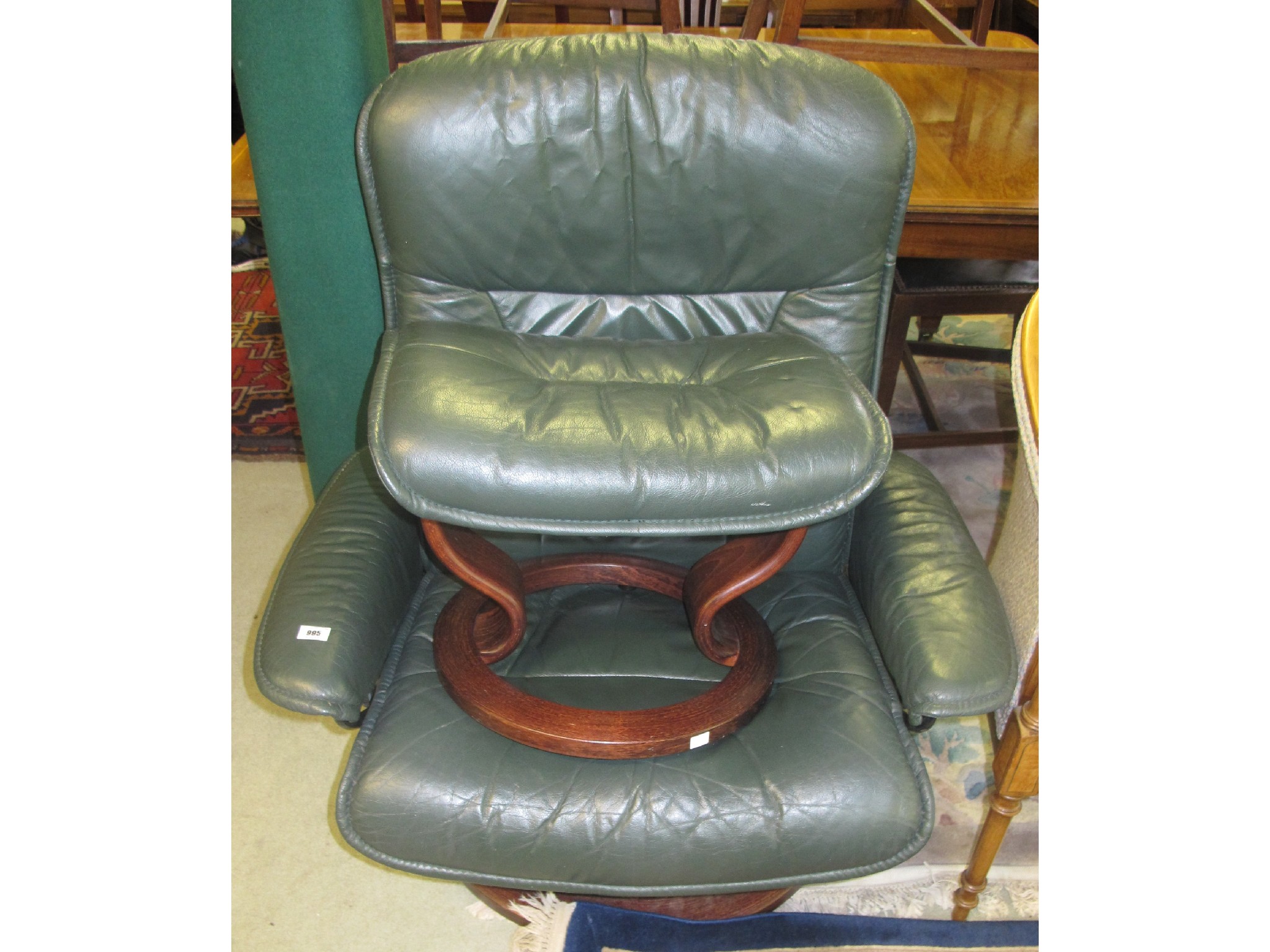 Appraisal: Green leather swivel chair and footstool