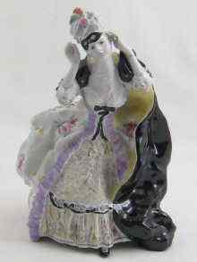 Appraisal: A Russian ceramic figure of a lady revealing her face