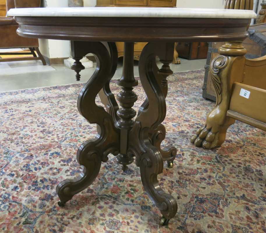 Appraisal: A VICTORIAN MARBLE-TOP WALNUT LAMP TABLE Renaissance Revial design American