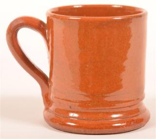 Appraisal: Glazed Redware Mug Cylindrical form applied loop handle molded base