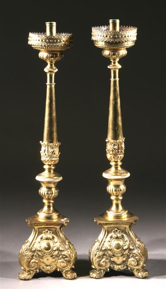 Appraisal: PAIR CONTINENTAL RENAISSANCE-STYLE BRASS ALTAR CANDLESTICKS th century Triangular bases