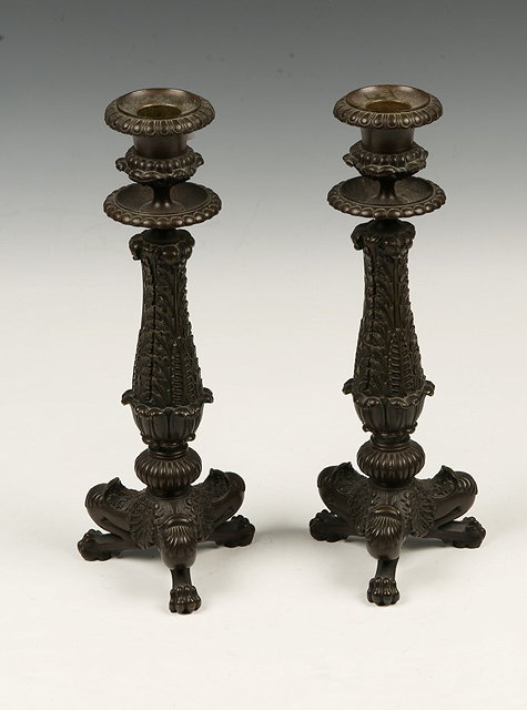 Appraisal: A PAIR OF REGENCY BRONZE CANDLESTICKS of classical acanthus form