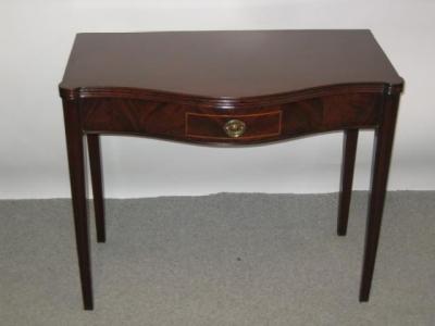 Appraisal: A GEORGE III MAHOGANY FOLDING TEA TABLE of oblong serpentine