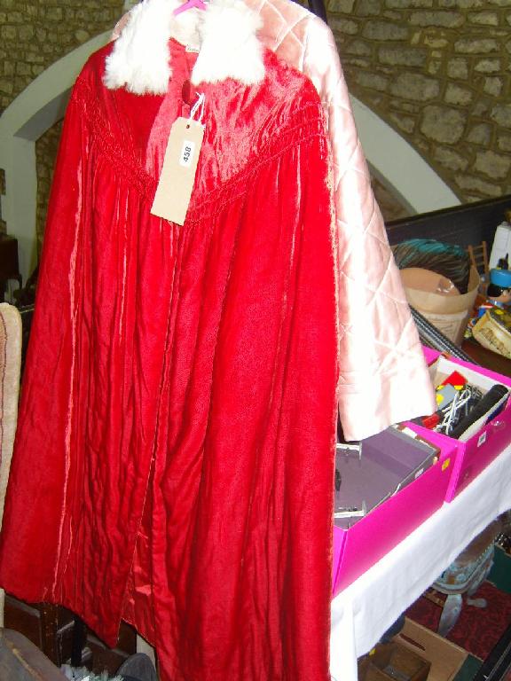 Appraisal: An early th century lined red velvet opera cloak with