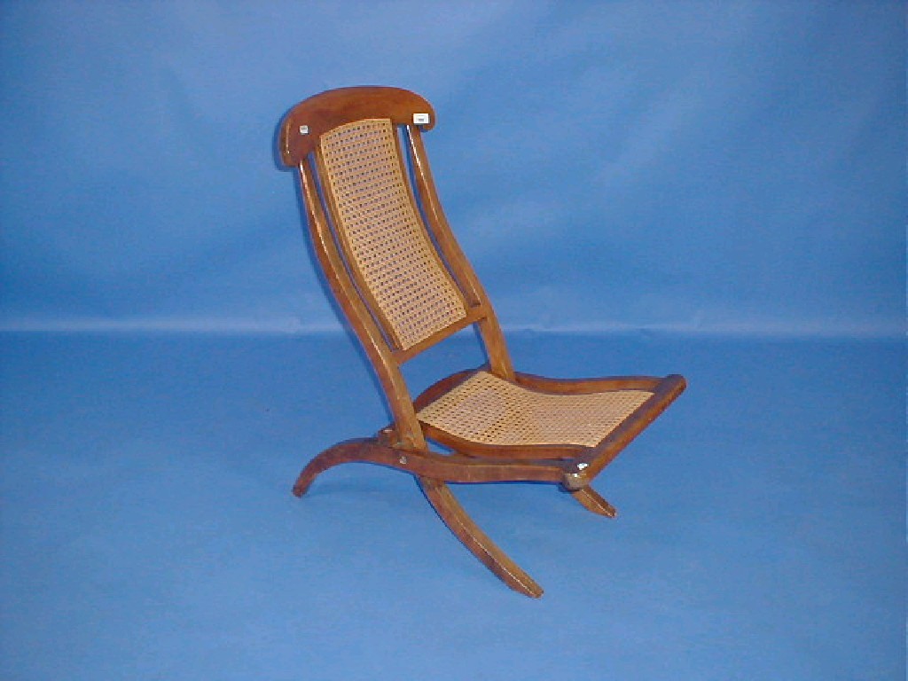 Appraisal: An Edwardian satin birch folding schooner chair