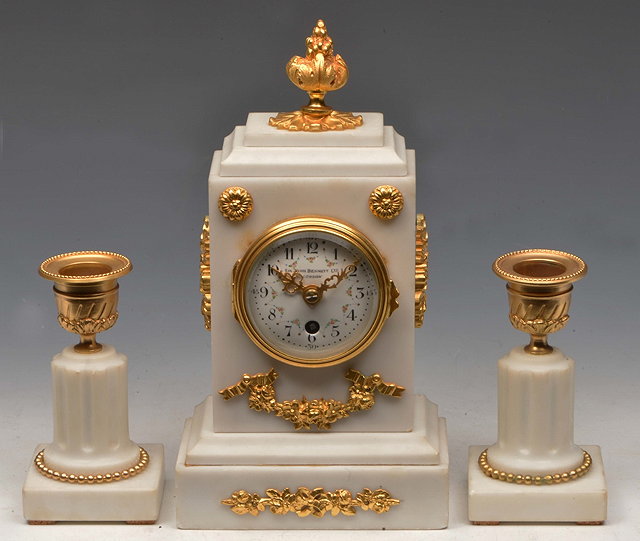 Appraisal: A WHITE MARBLE THREE PIECE BOUDOIR GARNITURE the timepiece with