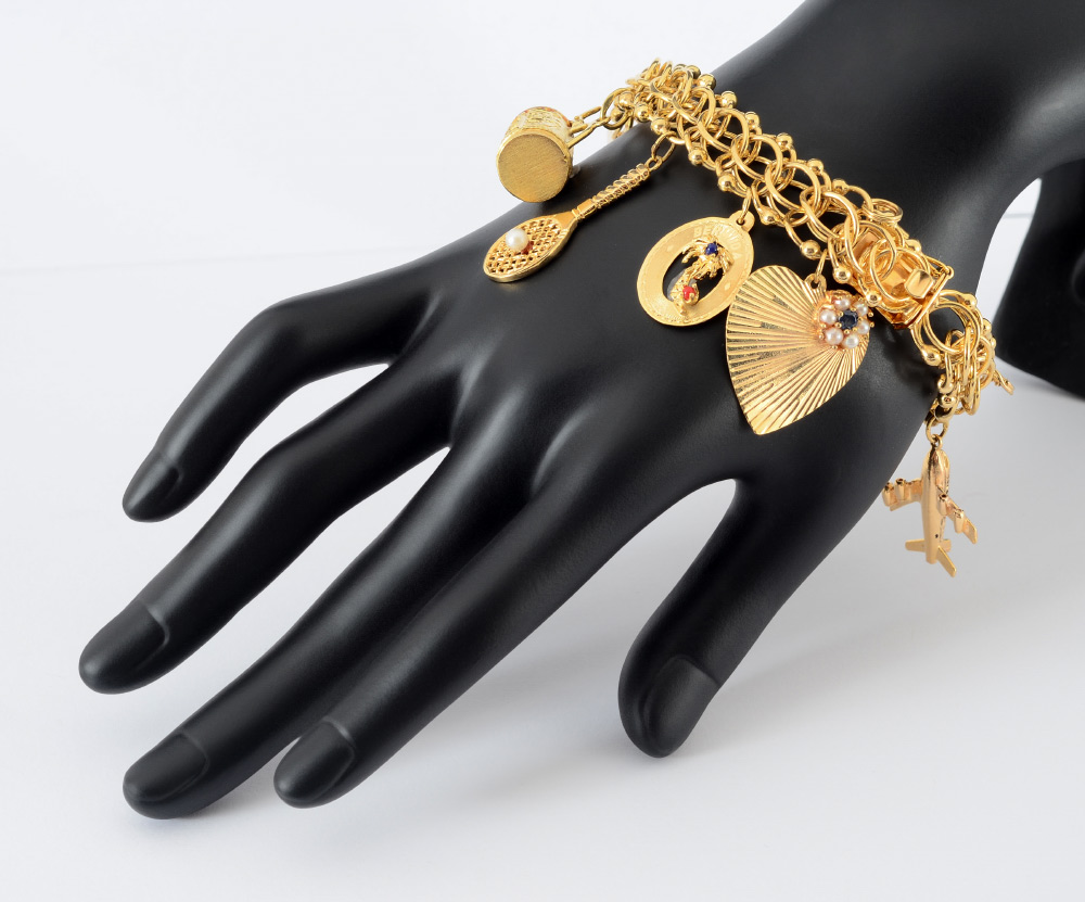 Appraisal: K GOLD CHARM BRACELET AND CHARMS Triple circle charm bracelet