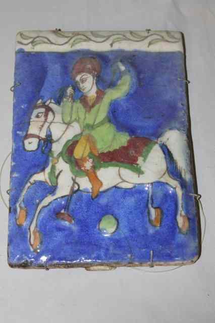 Appraisal: A PERSIAN BLUE GROUND TILE with equestrian figure x th