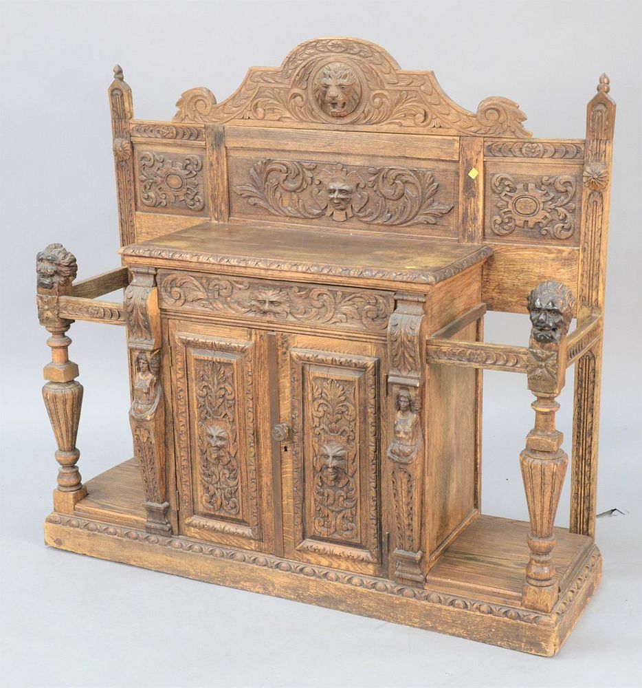 Appraisal: Continental heavily carved hall table cane holder having two doors