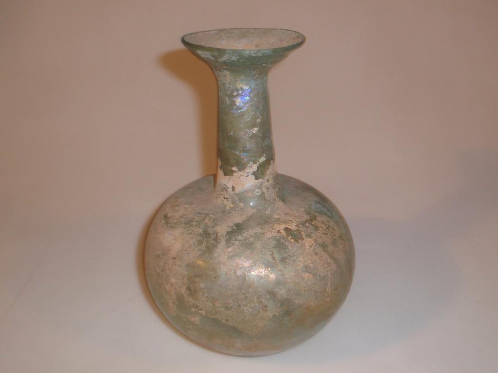 Appraisal: A large bluish-green Roman glass flask the flaring mouth with