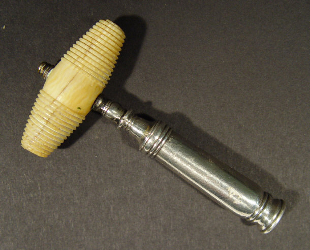 Appraisal: th Century silver pocket corkscrew and cover with turned ivory