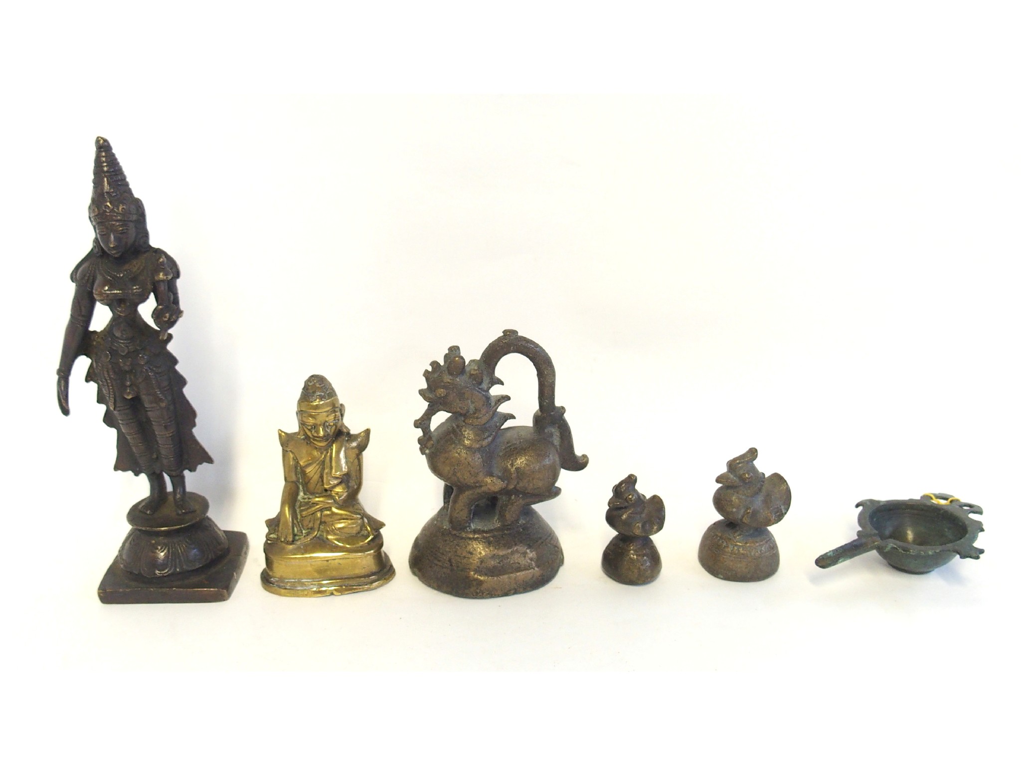 Appraisal: Three bronze opium weights an Indian deity figure a Burmese