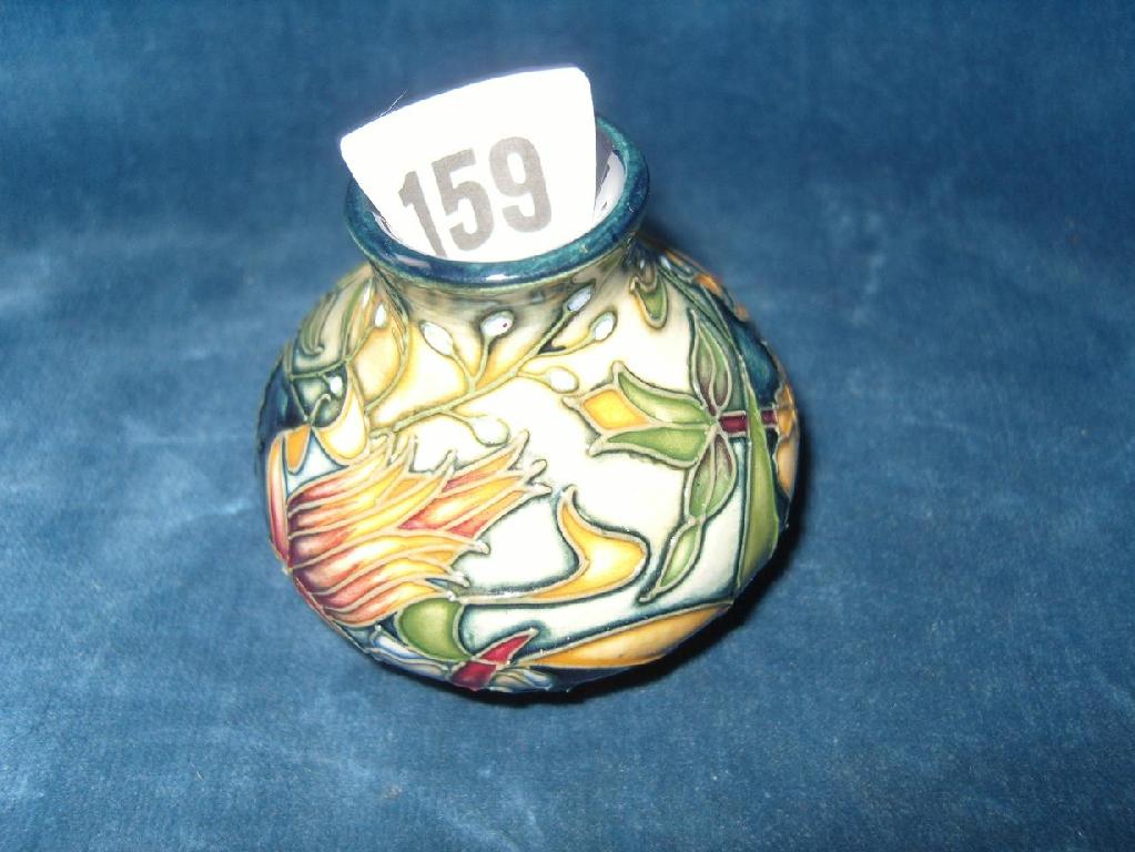 Appraisal: A miniature Moorcroft vase with painted stylised floral decoration on