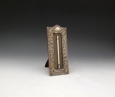 Appraisal: A late-Victorian silver mounted thermometer apparently unmarked upright arched rectangular