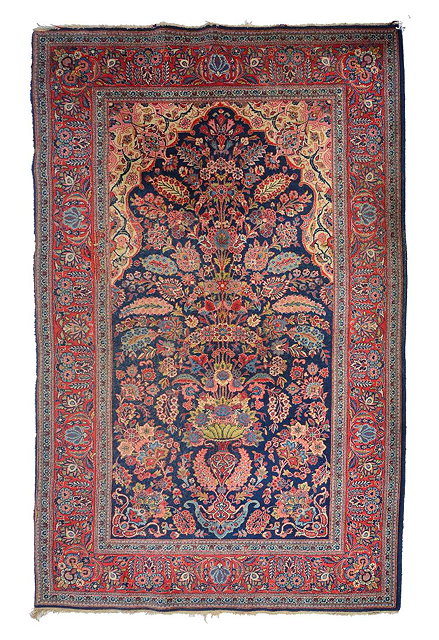 Appraisal: A PERSIAN BLUE AND RED GROUND RUG decorated a vase