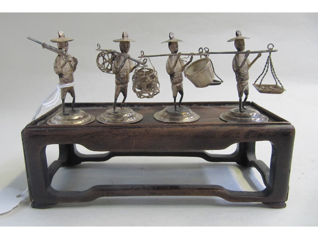 Appraisal: Lot comprising four oriental white metal figures and a hardwood