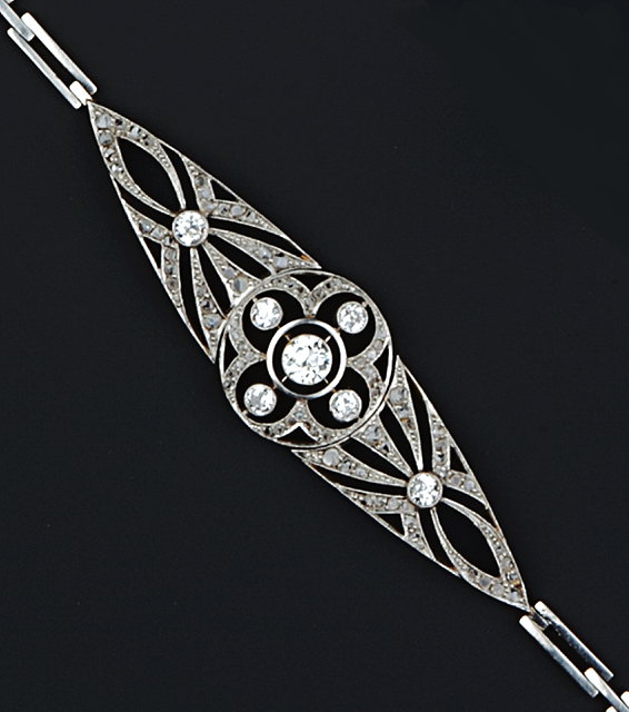 Appraisal: A DIAMOND SET PANEL BRACELET the articulated navette-shaped panel centred