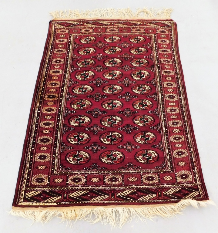 Appraisal: BUKARA RED GEOMETRIC RUG Middle East Circa - Navy blue