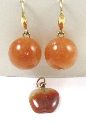 Appraisal: THREE ARTICLES OF ORANGE JADE JEWELRY including an apple shaped