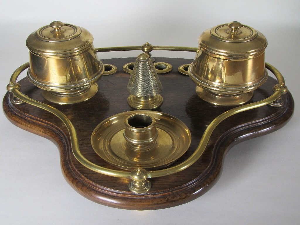 Appraisal: An Edwardian ship's oak and brass smoker's compendium the trefoil