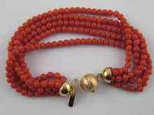 Appraisal: A five strand coral bead bracelet with a yellow metal