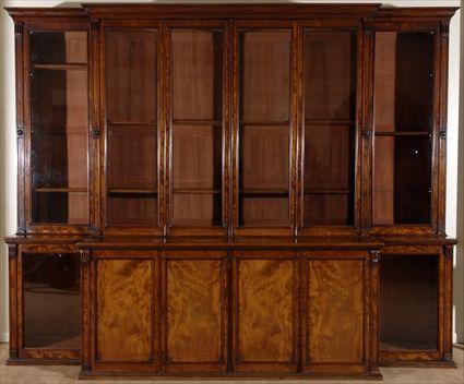 Appraisal: LATE REGENCY MAHOGANY BREAKFRONT BOOKCASE The plain figured molded cresting