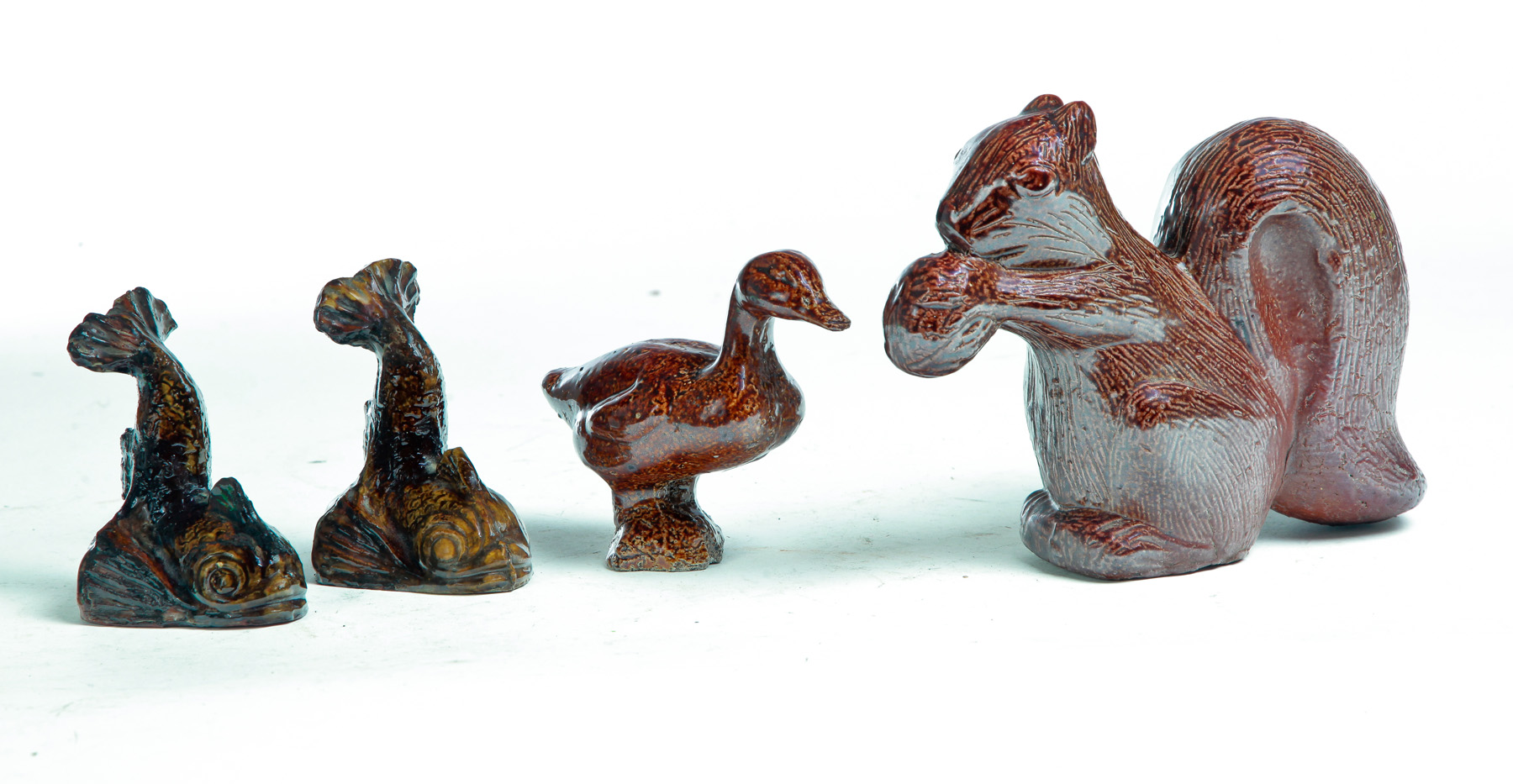 Appraisal: FOUR PIECES OF AMERICAN SEWERTILE Twentieth century Squirrel hairline h