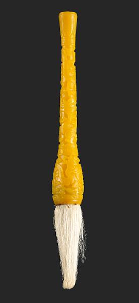 Appraisal: A yellow Peking glass brush handle Carved in high relief