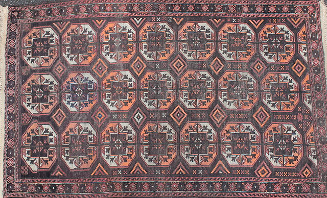 Appraisal: AN OLD BROWN GROUND BELOUCH RUG three rows of guls