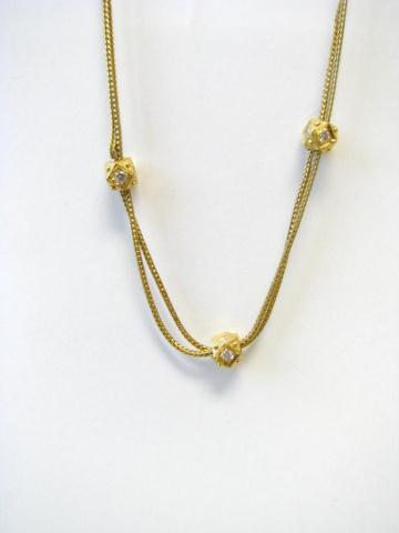 Appraisal: K yellow gold double strand necklace with three diamond accented