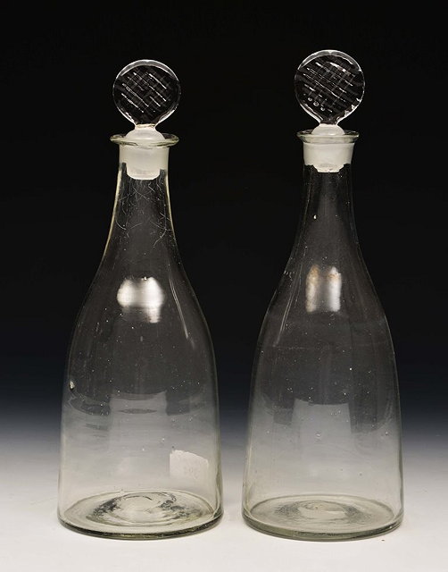 Appraisal: A PAIR OF ENGLISH GLASS TAPERING DECANTERS with stoppers circa