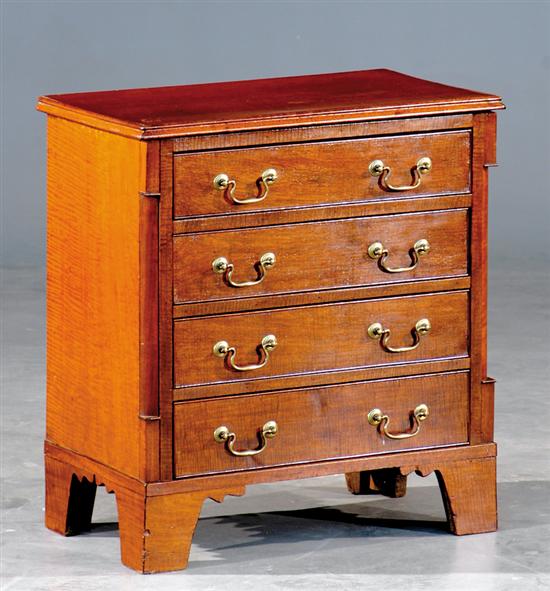 Appraisal: Miniature English quilted mahogany chest of drawers circa molded top