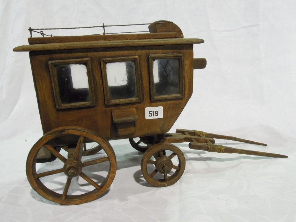 Appraisal: A model wooden stagecoach with glazed panelled windows