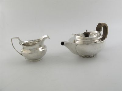 Appraisal: A George III small hemispherical teapot with a gadrooned 'cape'