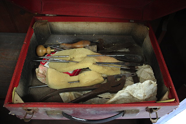 Appraisal: A SMALL QUANTITY OF UPHOLSTERY TOOLS held within a red