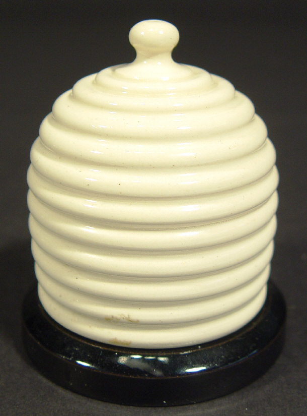 Appraisal: Novelty beehive shaped china match striker decorated in a cream