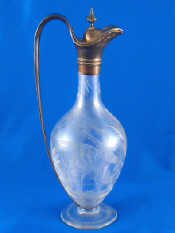 Appraisal: A silver mounted glass claret jug the body wheel engraved