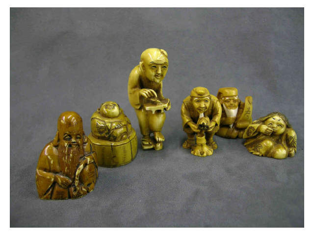 Appraisal: Group of six stained ivory netsuke including large man sitting