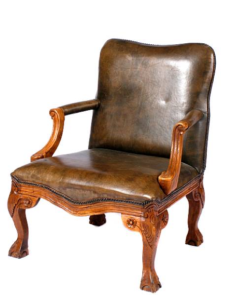 Appraisal: A Rococo style carved hardwood and leather upholstered armchair height