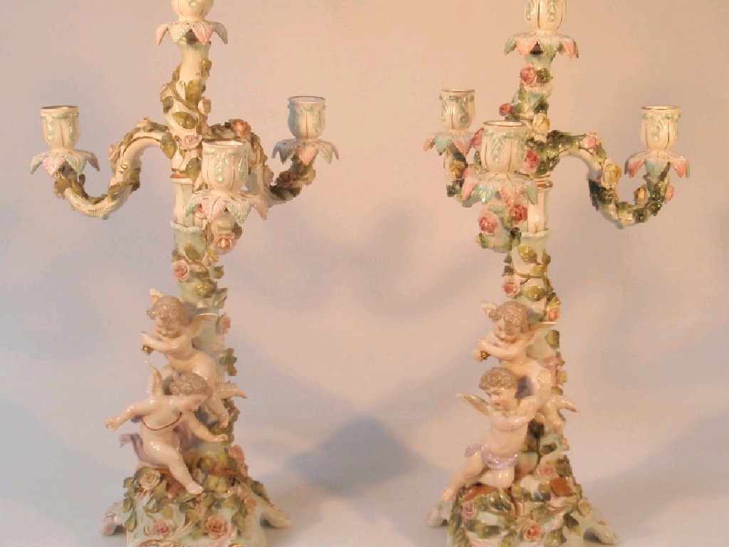 Appraisal: A pair of Sitzendorf porcelain four-light candelabra the three branches